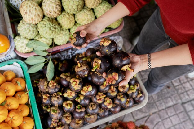 Customer buying eggplants