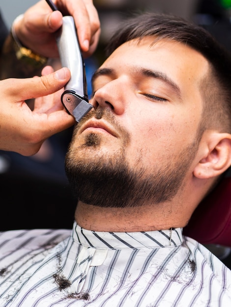 Customer getting his beard trimmed