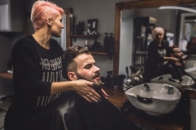 Free photo customer and hairdresser in barbershop