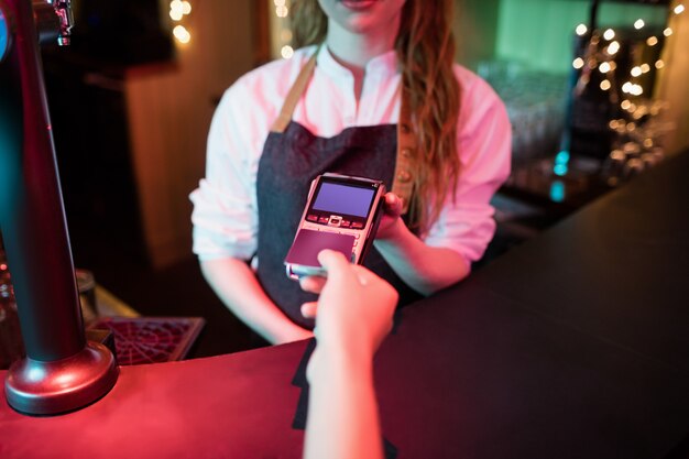 Customer making payment through credit card at counter