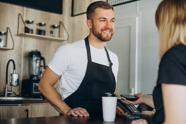 Customer paying with card in a coffee house