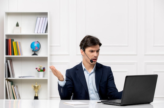 Customer service the cute brunette guy in the suit with laptop confused waving hands