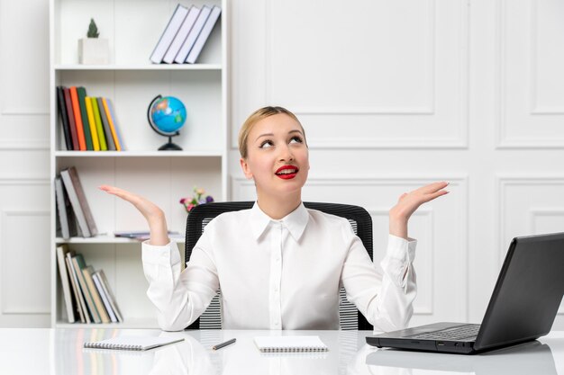 Customer service cute girl in white shirt with red lipstick and laptop looking up and smiling