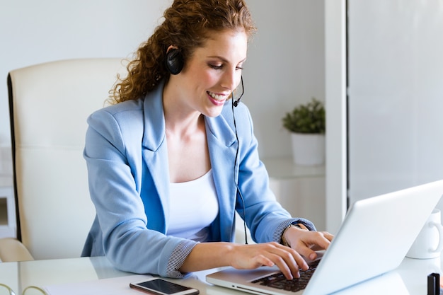 Customer service operator talking on phone in the office.