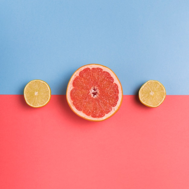 Cut citrus fruit on colorful background