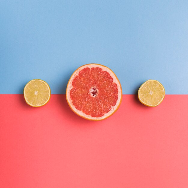 Cut citrus fruit on colorful background
