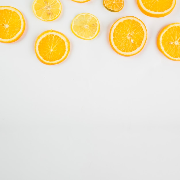 Free photo cut citruses on white background