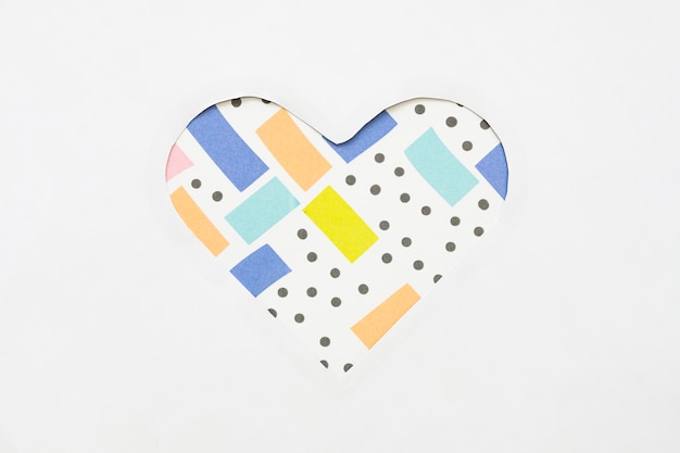 Free photo cut heart shape from paper on light table