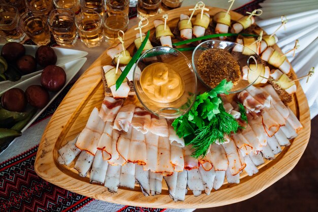 Cut meat lies on the original wooden dishes 