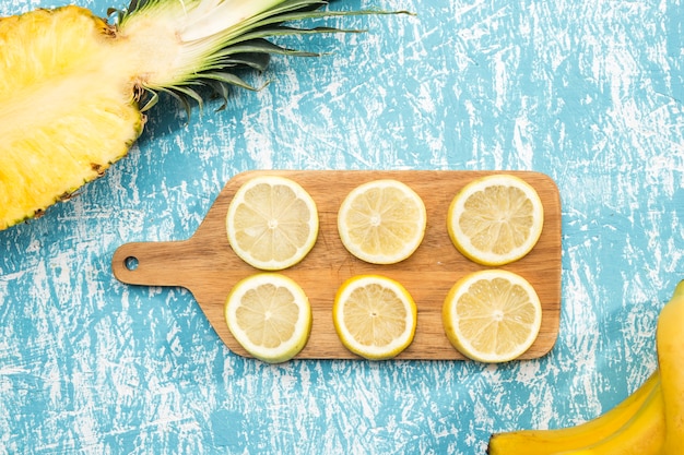 Cut slices of lemon on wooden board