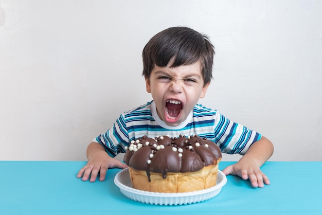 Premium Vector | Little kid boy eat a birthday cake