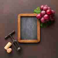 Free photo cute arrangement of grapes on blackboard