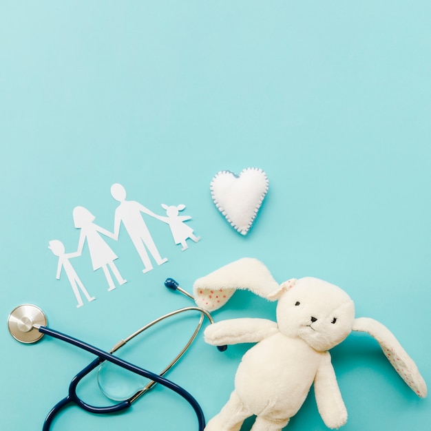 Cute arrangement of paper family on blue background with fluffy bunny