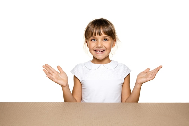 Cute and astonished little girl opening the biggest postal package