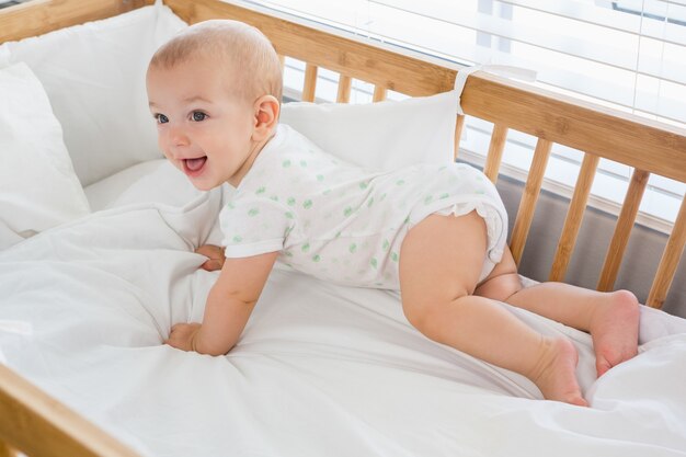 Cute baby boy on a cradle