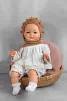 Free photo cute  baby doll for children still life