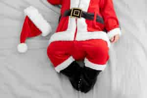 Free photo cute baby dressed in santa claus clothing