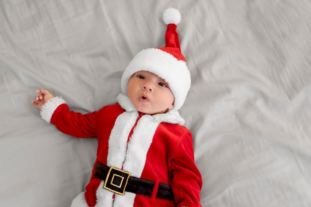 Cute baby dressed in santa claus clothing