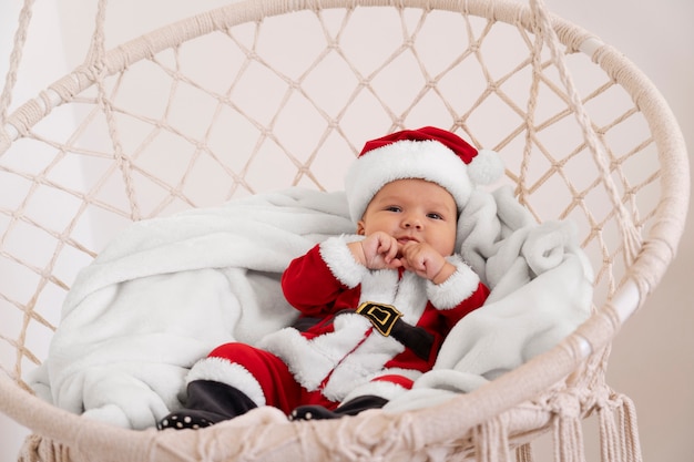 Cute baby dressed in santa claus clothing