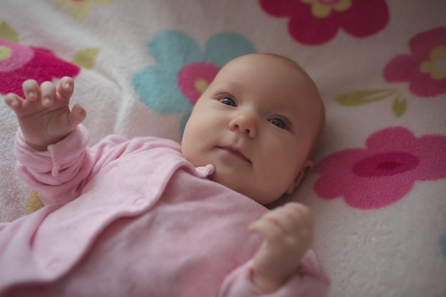 Cute baby lying in bed at home