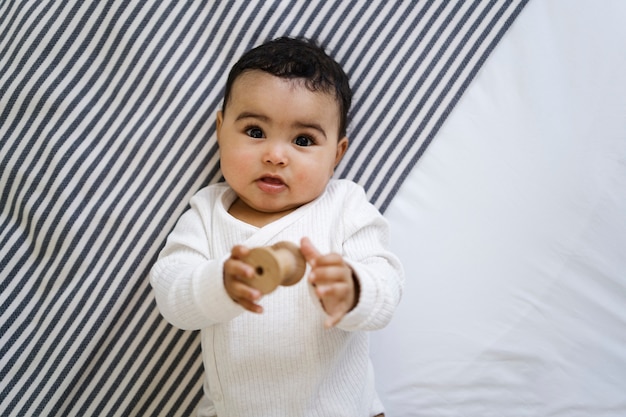 Free photo cute baby lying on bed