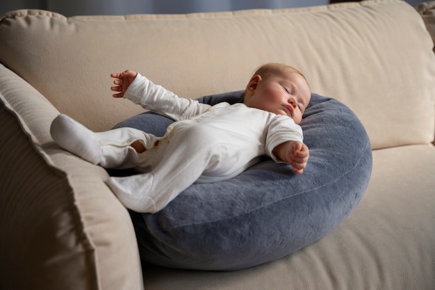 Free photo cute baby on nursing pillow