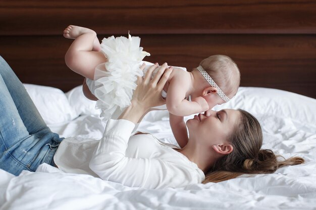 cute baby with mother at home