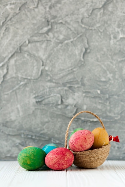 Free photo cute basket and colored eggs