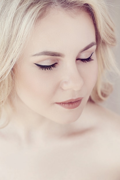 Cute beautiful blonde woman portrait, eyes closed