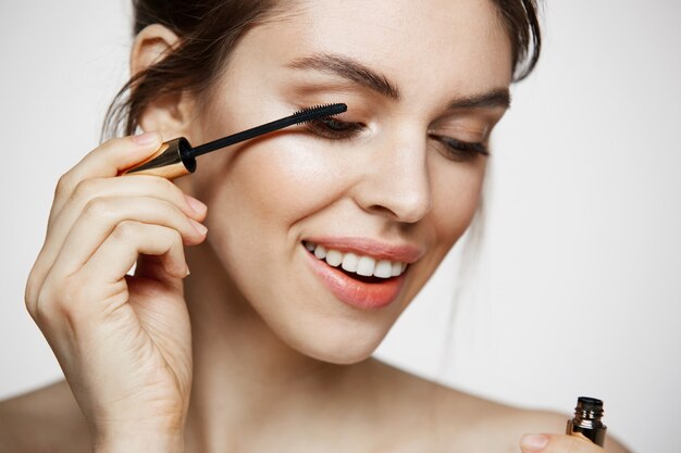 cute beautiful girl   dye eyelashes smiling over white background. beauty health and cosmetology concept.