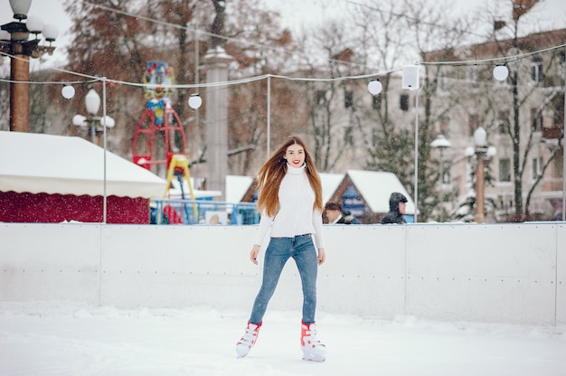 Free photo cute and beautiful girl in a white sweater in a winter city