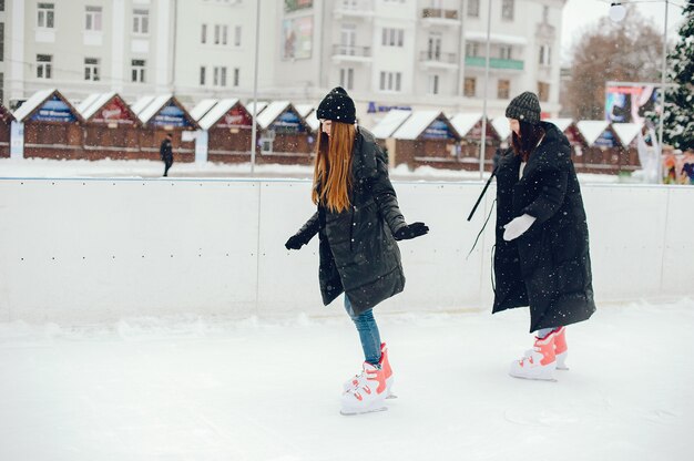 Cute and beautiful girls in a white sweater in a winter city