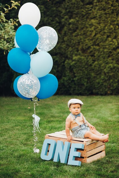 Cute birthday boy in the garden