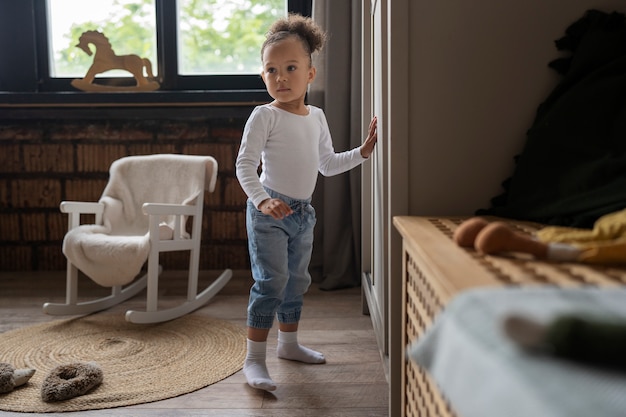 Cute black baby having fun at home