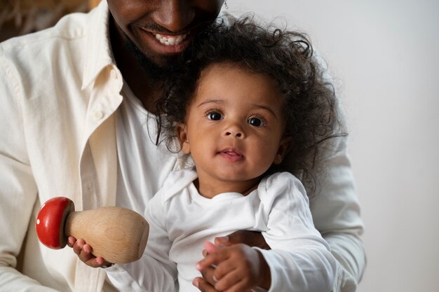 Cute black baby at home with parents