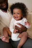 Free photo cute black baby at home with parents