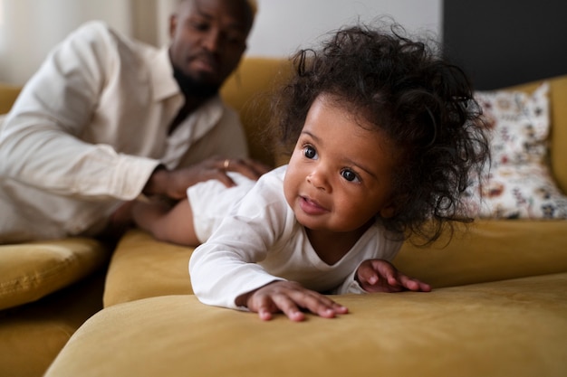 Cute black baby at home with parents