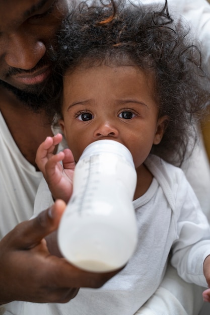 Cute black baby at home with parents