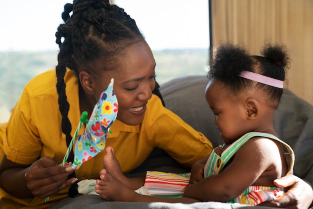 Free photo cute black baby at home with parents