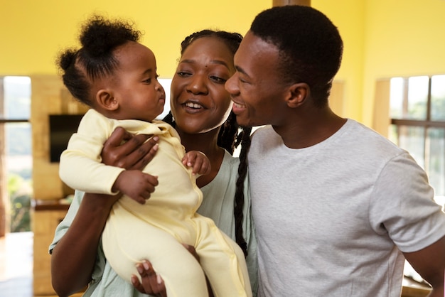 Cute black baby at home with parents