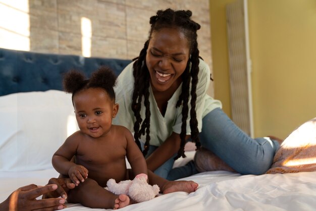 Cute black baby at home with parents