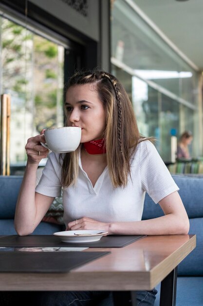 Cute blonde drinking coffee at the restaurant