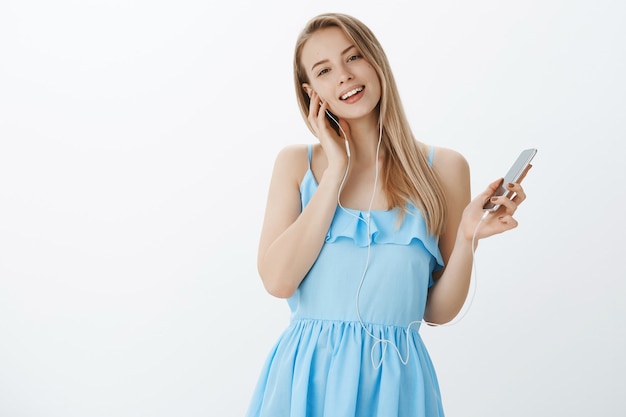 Cute blonde girl in stylish blue dress