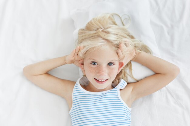 Cute blonde little girl in bed