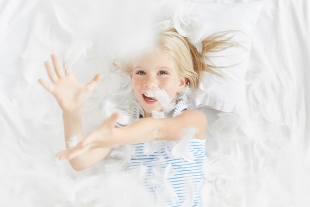 Cute blonde little girl in bed