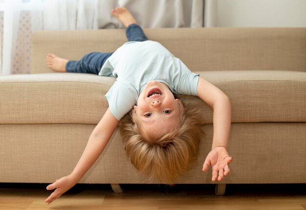 Cute boy on couch playing