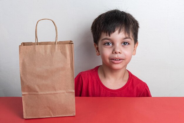 Free photo cute boy holding fast food shopping bag