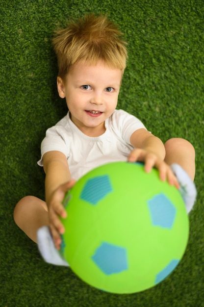 Cute boy playing with football