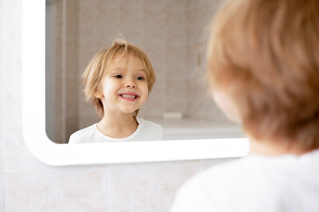 Cute boy smiling in mirror