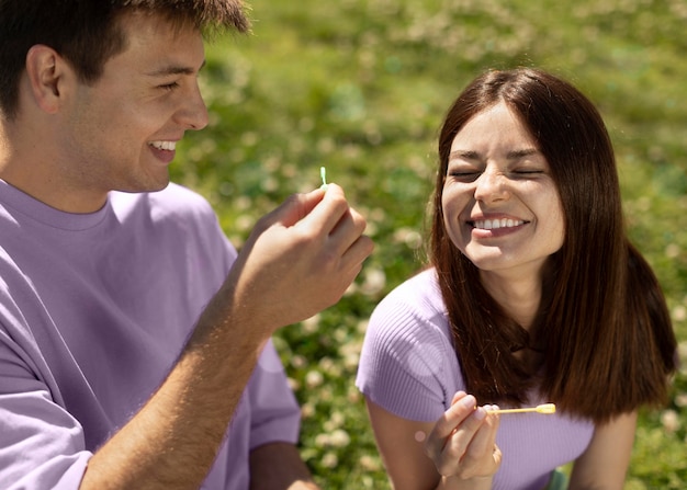 Free photo cute boyfriend and girlfriend playing with soap bubbles